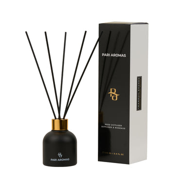 Tranquil Shores reed diffuser with chamomile, blue amber, and spearmint in a glass vessel with natural reeds for a calming scent