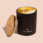 Floral and fruity soy candle with vanilla, jasmine, and clove set in a serene, palm-inspired space

