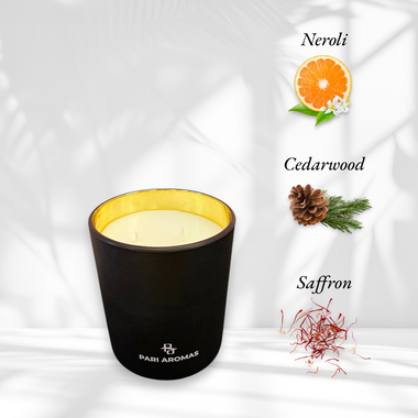 Hand-poured coconut soy candle in a glass jar with notes of neroli, saffron, and cedarwood for a rich and tropical aroma.